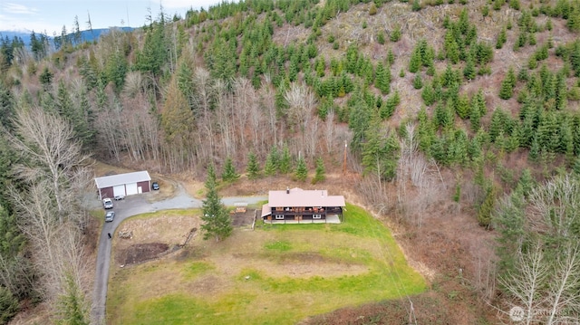 drone / aerial view with a wooded view