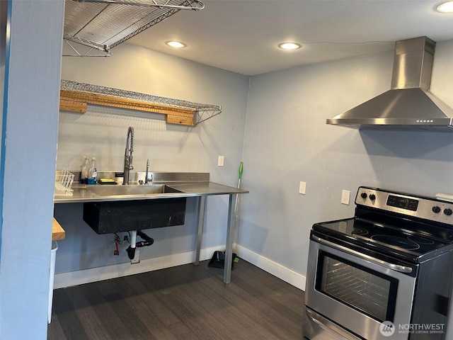 kitchen with stainless steel countertops, baseboards, dark wood-style floors, wall chimney exhaust hood, and stainless steel range with electric stovetop