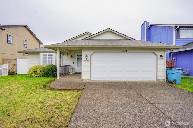 view of front of property with concrete driveway, a front lawn, an attached garage, and fence