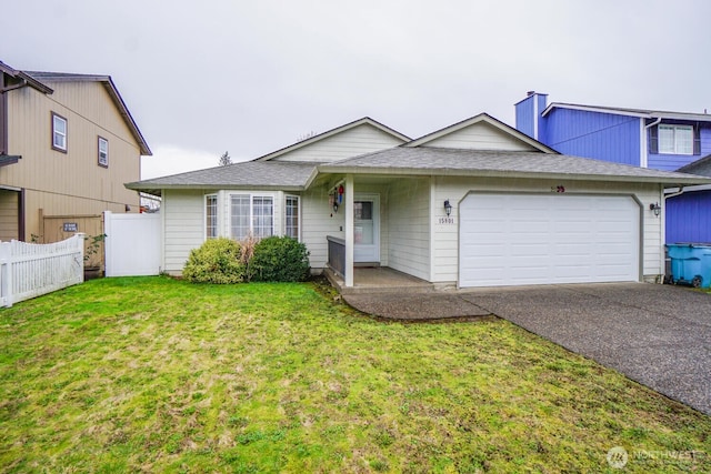 ranch-style home featuring a chimney, an attached garage, a front yard, fence, and driveway