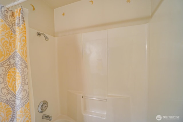 bathroom with shower / bath combo with shower curtain