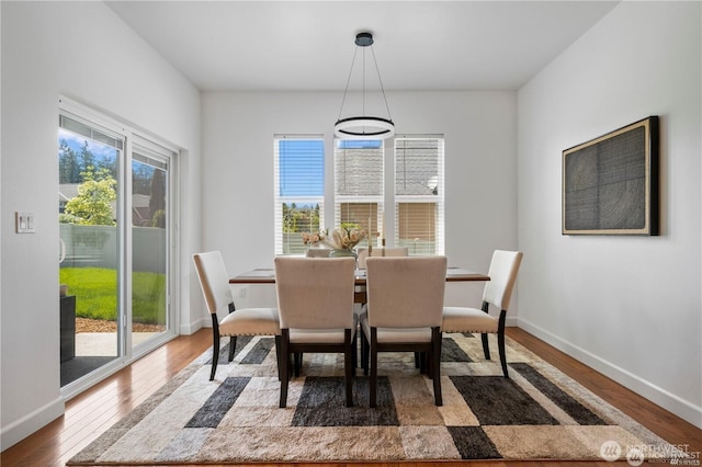 dining space with wood finished floors and baseboards