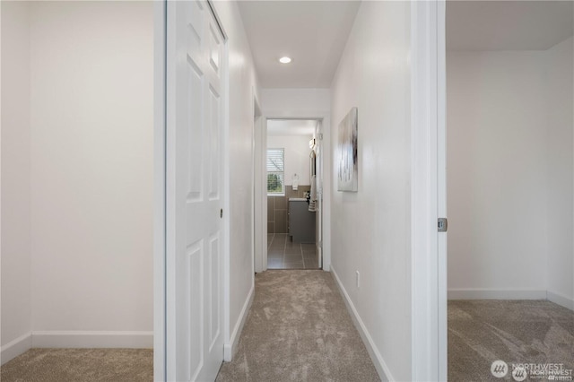 hallway with recessed lighting, carpet, and baseboards