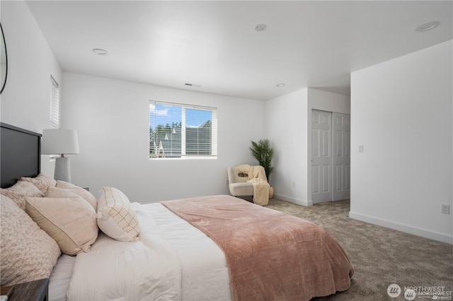 bedroom with carpet floors, visible vents, and baseboards