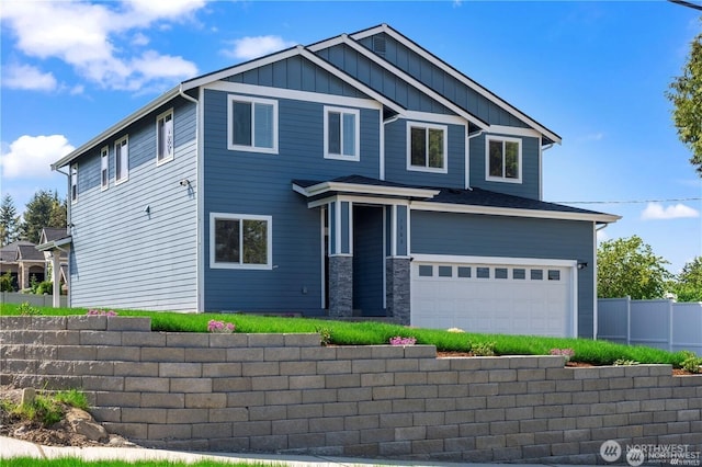 view of front of house featuring stone siding, board and batten siding, and fence