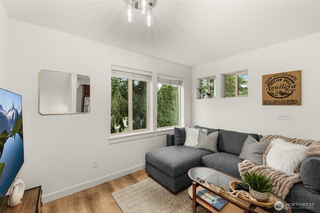 living room featuring light wood-style flooring and baseboards