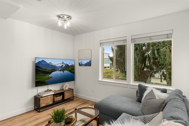 living area with baseboards and light wood-style floors