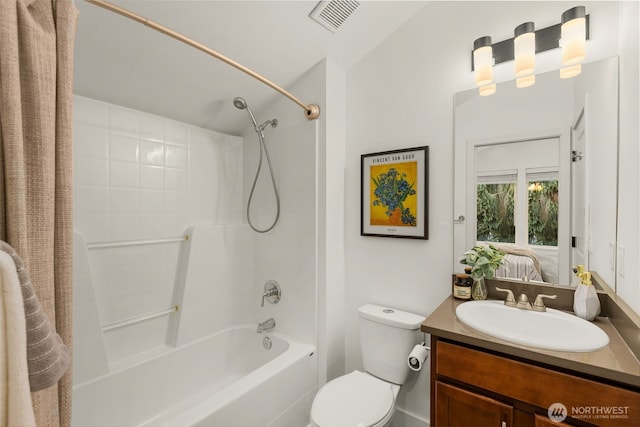 bathroom featuring ensuite bathroom, toilet, vanity, visible vents, and shower / bathing tub combination