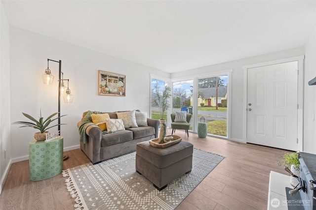 living room with light wood-style floors and baseboards