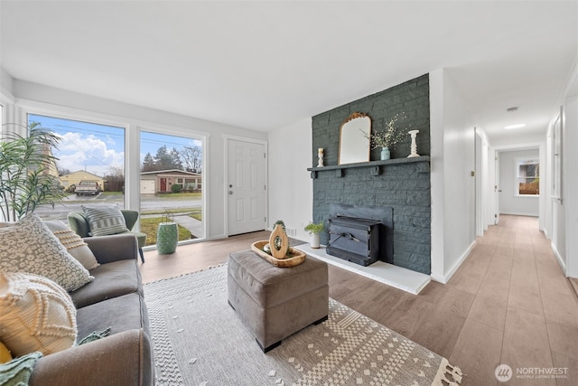 living area featuring light wood-type flooring and baseboards