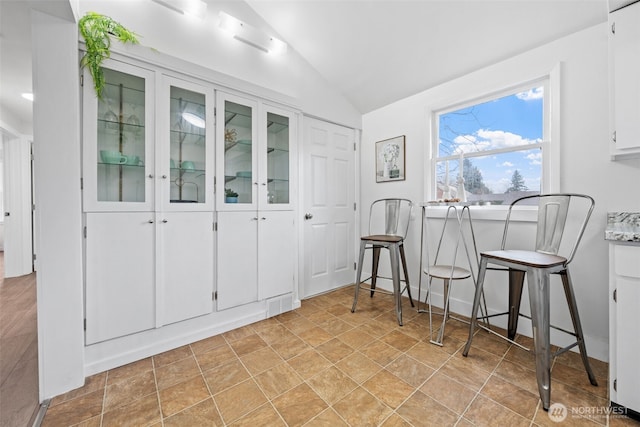 dining area featuring lofted ceiling