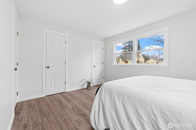 bedroom featuring light wood-style flooring and baseboards