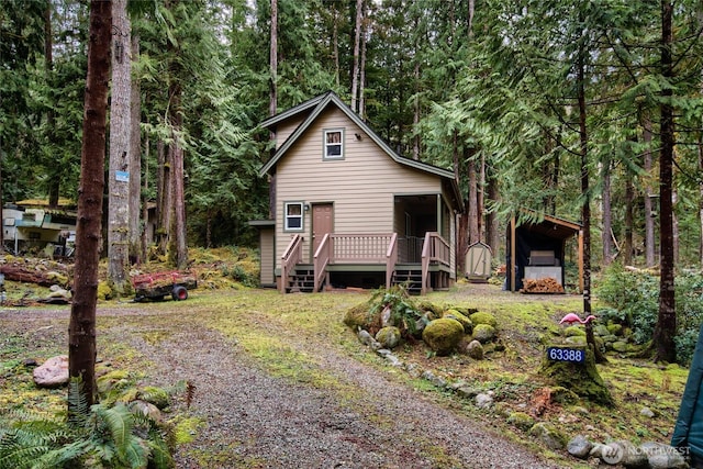 rustic home with driveway and a deck