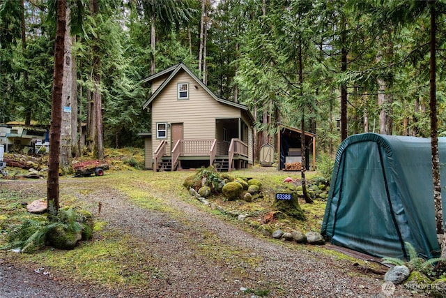 exterior space with driveway and a deck