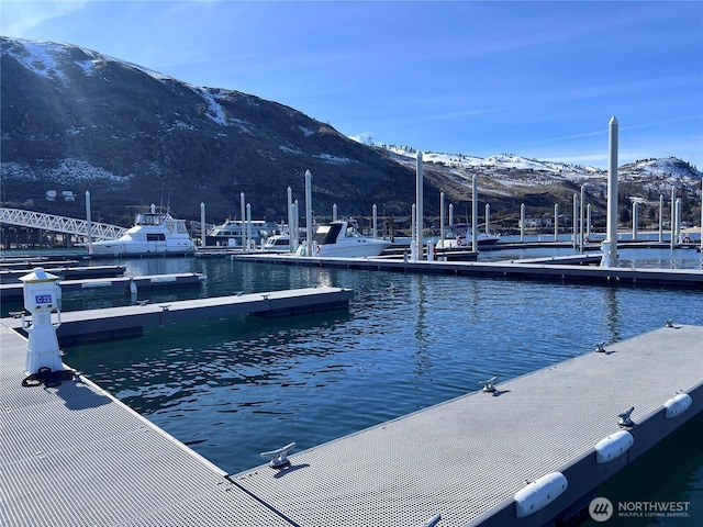 view of dock with a water and mountain view