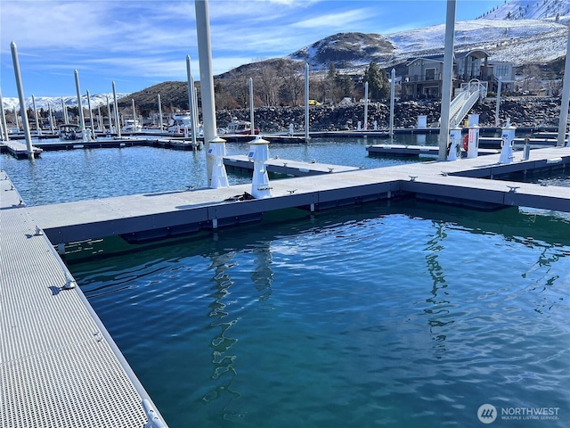 view of dock with a water and mountain view