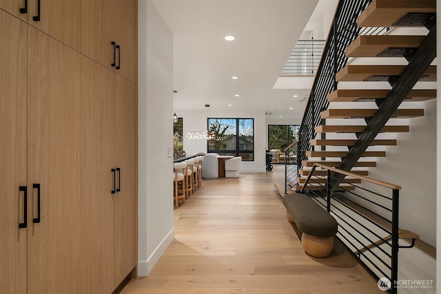 hall featuring stairway, recessed lighting, light wood-type flooring, and baseboards