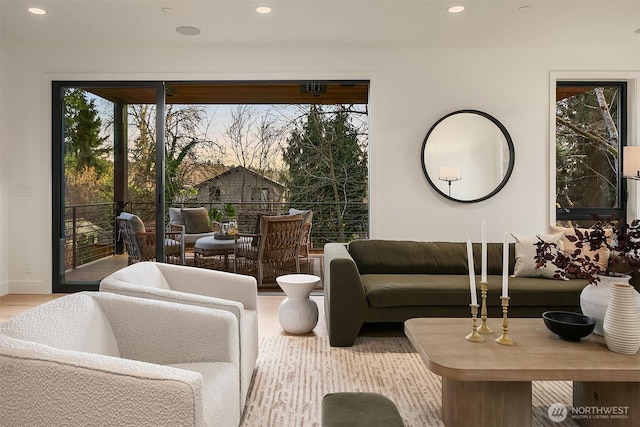 living area with recessed lighting and wood finished floors