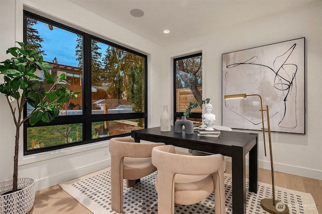 dining area featuring recessed lighting, baseboards, and light wood finished floors