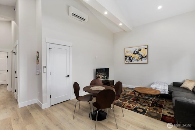 dining room with beam ceiling, recessed lighting, light wood-style flooring, an AC wall unit, and baseboards