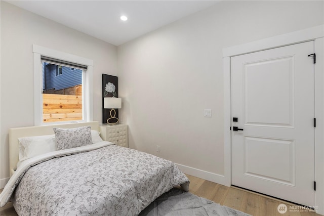 bedroom with recessed lighting, light wood-style flooring, and baseboards