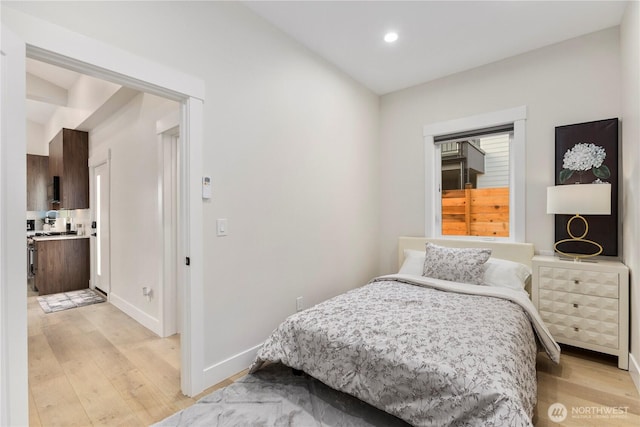 bedroom with recessed lighting, baseboards, and light wood finished floors