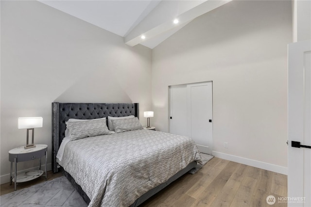 bedroom featuring high vaulted ceiling, recessed lighting, wood finished floors, and baseboards