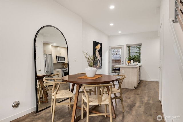 dining area featuring baseboards, dark wood-style flooring, and recessed lighting