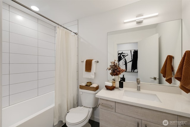 bathroom featuring toilet, recessed lighting, shower / bath combo with shower curtain, and vanity