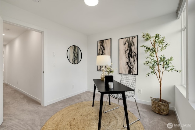 office space featuring baseboards and light colored carpet