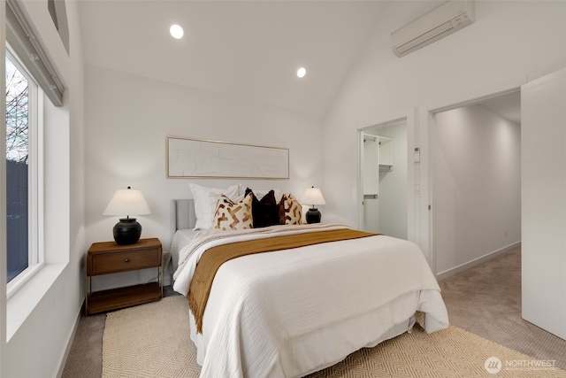 bedroom with a wall unit AC, recessed lighting, light colored carpet, baseboards, and vaulted ceiling