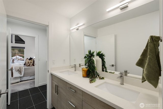 bathroom featuring double vanity, tile patterned flooring, a sink, and connected bathroom