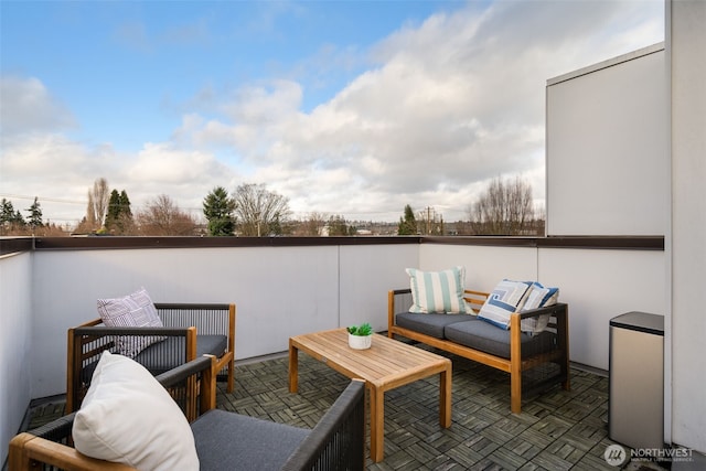 view of patio with an outdoor living space and a balcony