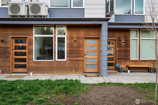 view of exterior entry with ac unit