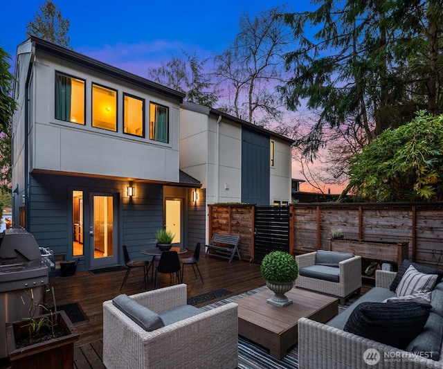 deck featuring grilling area, fence, outdoor lounge area, and french doors