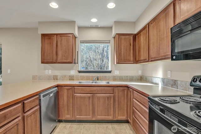 kitchen with black appliances, light countertops, a sink, and visible vents