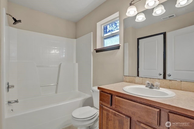 bathroom with visible vents, bathing tub / shower combination, vanity, and toilet