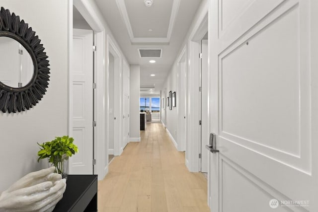 hallway featuring recessed lighting, light wood-style floors, visible vents, and baseboards