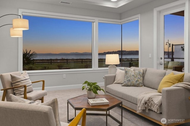 living area featuring visible vents, baseboards, and carpet