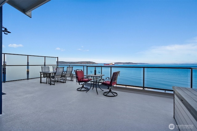 view of patio featuring a water view and a balcony