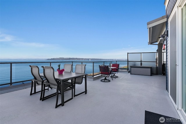 view of patio / terrace featuring a water view and a balcony