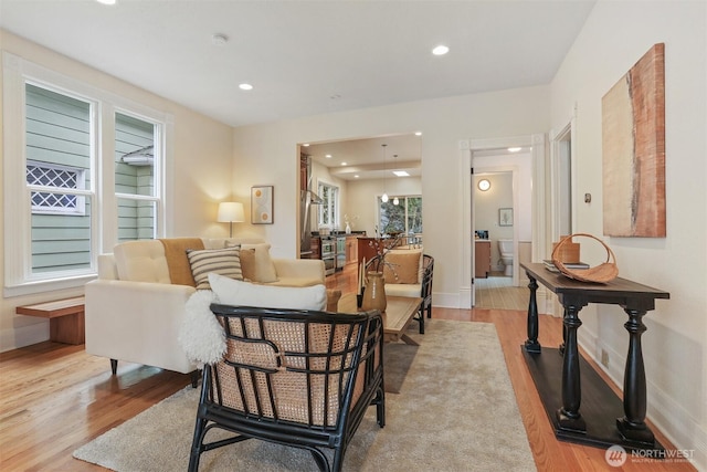 sitting room featuring recessed lighting, light wood-style flooring, and baseboards