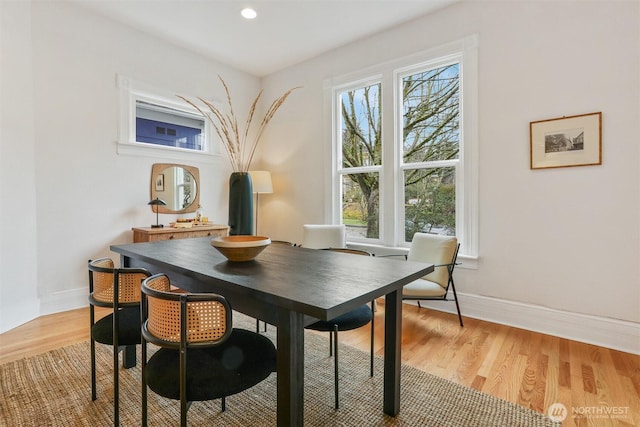 dining room featuring light wood-style floors, baseboards, and recessed lighting