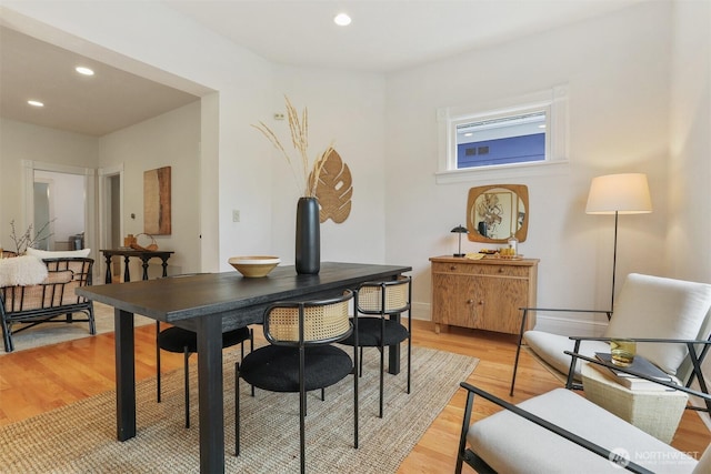 dining space featuring light wood-type flooring and recessed lighting