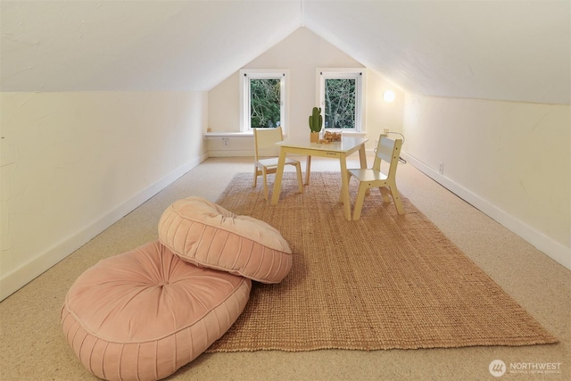 interior space featuring lofted ceiling, carpet flooring, and baseboards