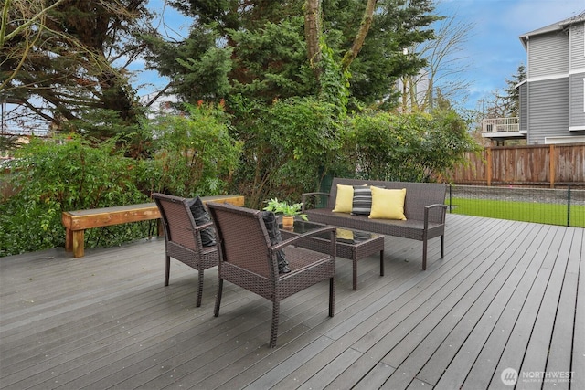 wooden terrace featuring fence and outdoor lounge area