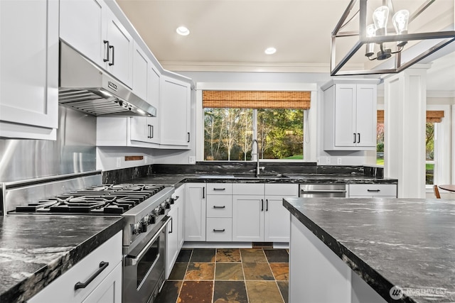 kitchen with high end stainless steel range, stone finish flooring, white cabinetry, a sink, and under cabinet range hood