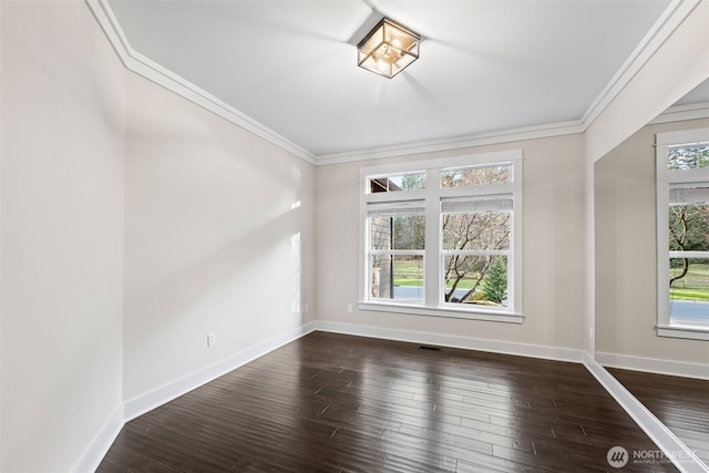 unfurnished room featuring a healthy amount of sunlight, dark wood finished floors, and crown molding