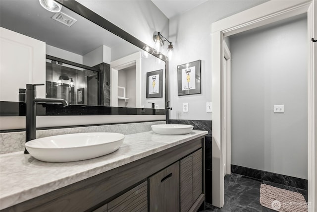 full bathroom featuring marble finish floor, visible vents, a sink, and double vanity