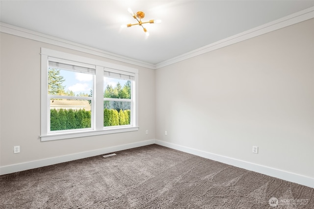 empty room with carpet, visible vents, crown molding, and baseboards